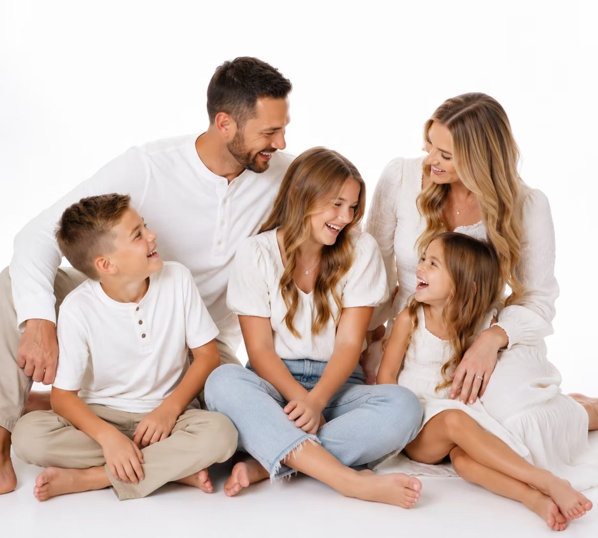 Family portrait session in white outfits at Atlanta Portrait Studio