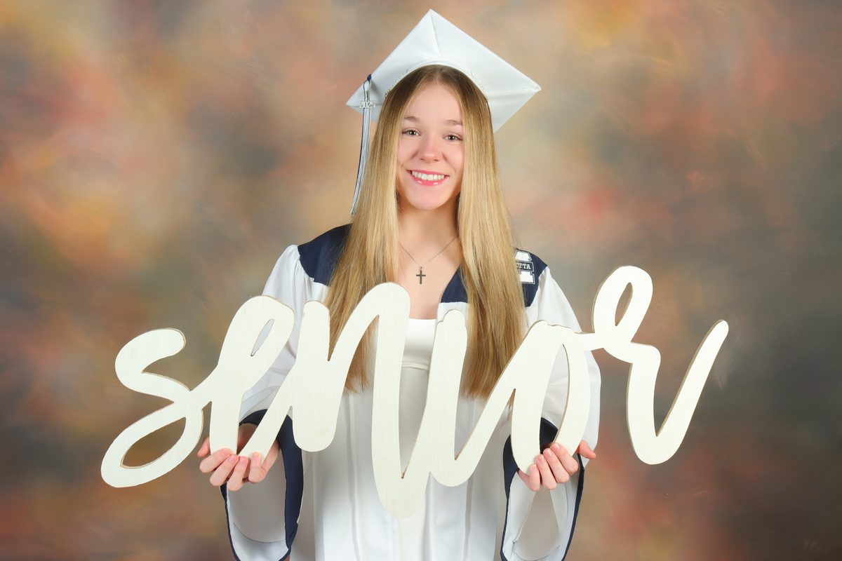 High school senior portrait with cap and senior sign