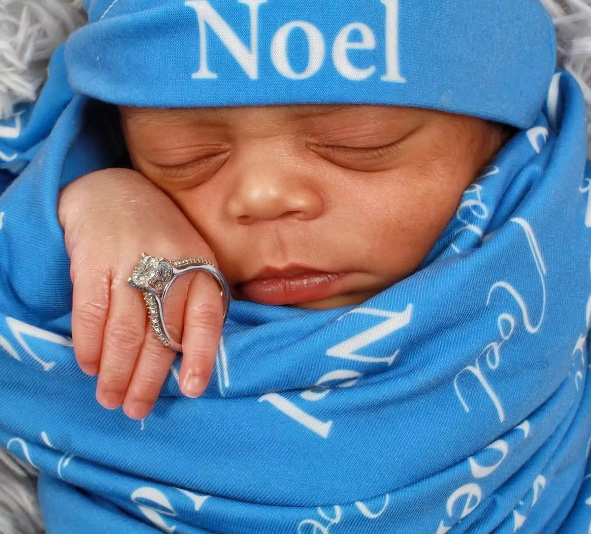 Newborn portrait wrapped in a blue personalized blanket