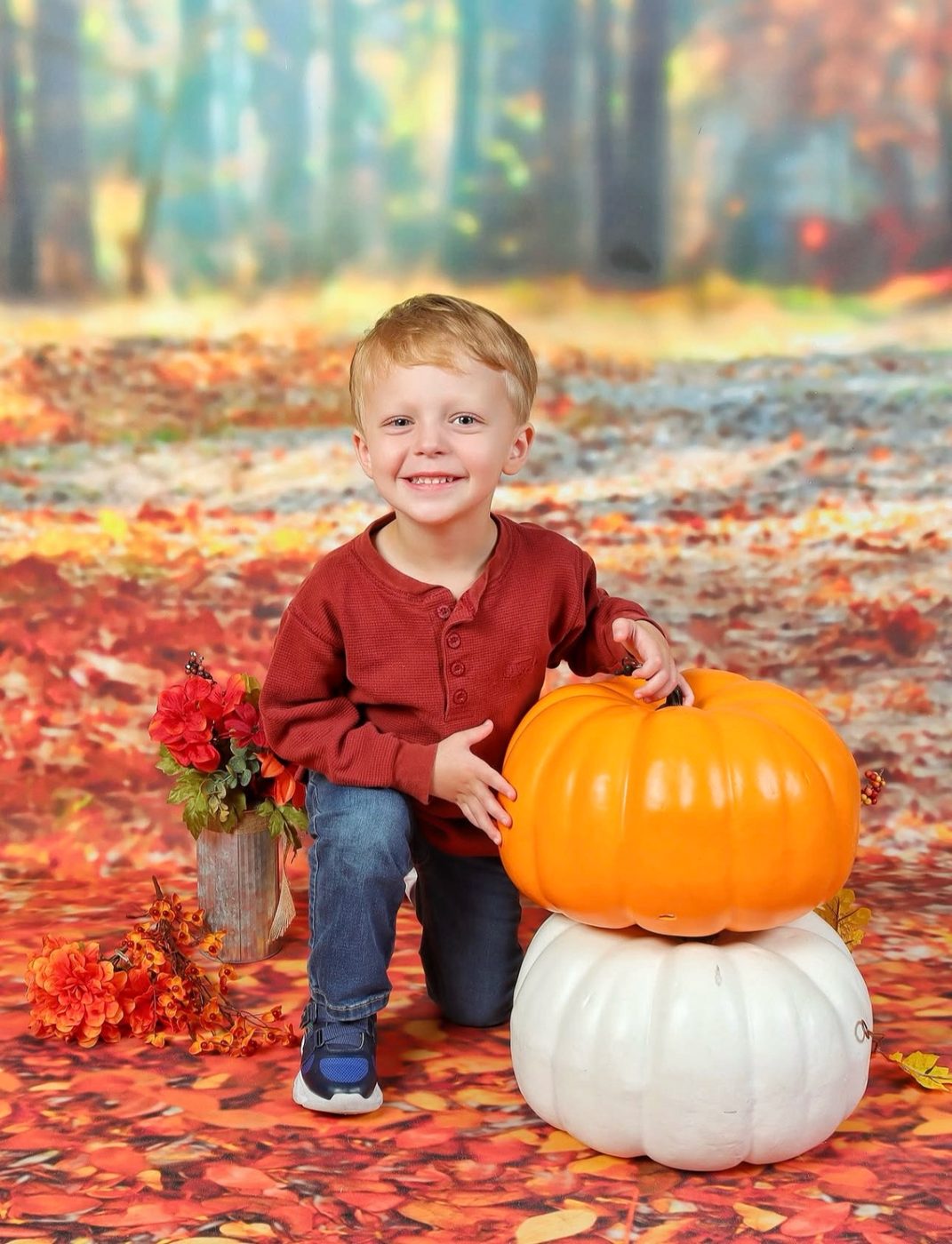 Little boy with pumpkins on the fall portrait set at Atlanta Portrait Studio
