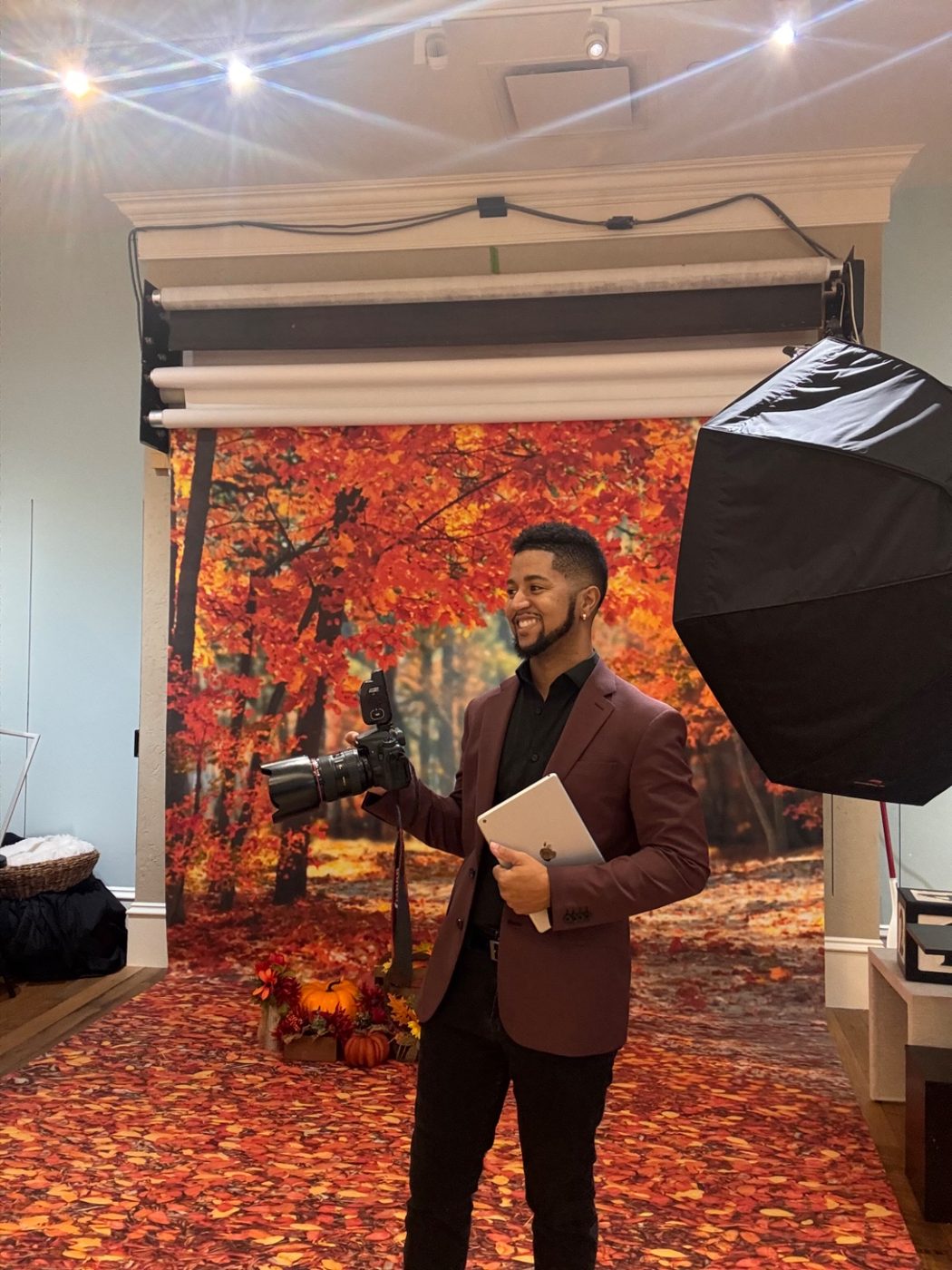 Photographer Jerry Walker on the fall set inside Atlanta Portrait Studio